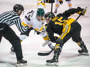 The Nipawin Hawks' Davin Smith, left, and the Estevan Bruins' Tanner Manz face off in Saturday's opener of the SJHL's championship series. The series is to return to Nipawin on Friday for Game 5.