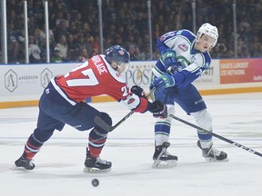Noah King of the Swift Current Broncos gets a shot away in front of Lethbridge Hurricanes forward Logan Barlage during Game 5 of the Eastern Conference final on Saturday in Swift Current.