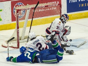 Regina Pats netminder Ryan Kubic stops a shot by the Swift Current Broncos' Tanner Nagel on Saturday.