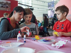 Laura Cichocki, from left, Ronan Cichocki and Seth Cichocki take a break from an Easter-themed scavenger hunt at the RCMP Heritage Centre in Regina on March 31, 2018.