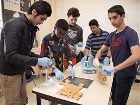 Sheldon-Williams Collegiate students Nima Alizaee (from left), Khalid Hassan, Michael Schmidt, Mohamad Alhajji and Houman Alimardani make s'mores as a fundraiser for their outdoor club in Regina.  The s'mores will be sold at the Banff Mountain Film Festival.