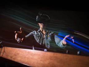 Leader-Post reporter Jennifer Ackerman tests out John Desnoyers-Stewart's virtual reality installation on display at the Fifth Parallel Gallery at the University of Regina.