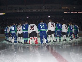 Members of the Swift Current Broncos and Moose Jaw Warriors stand together at Mosaic Place on Saturday to honour the Humboldt Broncos.