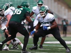 Terran Vaughn (right) has stood out at offensive tackle for the Riders during training camp.