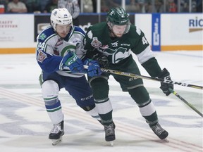 Garrett Pilon of the Everett Silvertips battles with Matteo Gennaro of the Swift Current Broncos during Game 2 of the WHL final on Saturday. Photo courtesy Robert Murray/WHL.