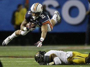 Auburn running back Tre Mason (21) makes the catch against Missouri defensive back John Gibson (1) during the first half of the Southeastern Conference NCAA football championship game, Saturday, Dec. 7, 2013, in Atlanta.