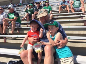 Dave Herron and his grandchildren, two-year-old Ashton (left) and four-year-old Braylon (right) attend the Saskatchewan Roughriders training camp at Griffiths Stadium on the University of Saskatchewan campus in Saskatoon, Sask., on Wednesday, May 23, 2018.