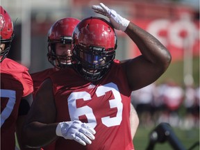 Calgary Stampeders' Derek Dennis adjusts his helmet on opening day of training camp in Calgary, Sunday, May 20, 2018.