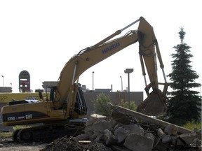 A Trac Hoe from Hazco construction was busy ripping out concrete from a site where an Esso gas station once stood on Victoria Ave, in this 2010 file photo. The site was set to be analyzed for contaminants. The city is now studying how to encourage remediation of similar sites.