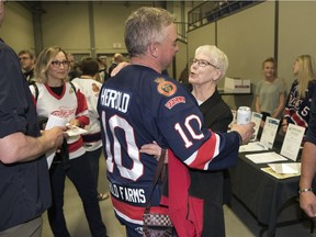 Russ Herold gets a hug during the Adam Herold memorial game on May 11 at the Co-operators Centre. Adam Herold was among 16 people killed in the Humboldt Broncos' bus crash.