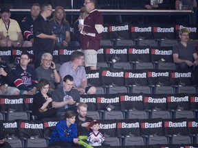 Hockey fans and empty seats are seen prior to the start of a game between the Acadie-Bathurst Titan and the Hamilton Bulldogs during the Memorial Cup in Regina on Tuesday, May, 22, 2018. The organizing committee chair for the 100th Memorial Cup says that a high fee to host the tournament has caused increased ticket prices which has impacted attendance.