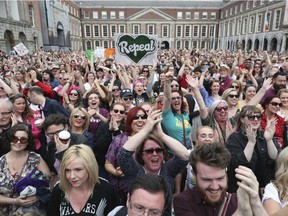 Members of the public celebrate at Dublin Castle, in Dublin, Ireland, Saturday, May 26, 2018, after the results of the referendum on the 8th Amendment of the Irish Constitution which prohibits abortions unless a mother's life is in danger.