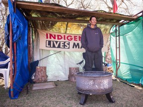 Prescott Demas stands in a shelter at the Justice for Our Indigenous Children camp across from the legislative building.