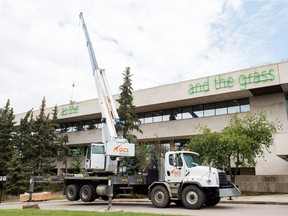 Workers install a sculpture by artist Duane Linklater, an internationally renowned Canadian artist, on top of the MacKenzie Art Gallery on Albert Street. When finished, the sculpture is to read "As long as the sun shines, the river flows, and the grass grows."