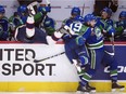 Regina Pats defenceman Liam Schioler, left, gets checked the Swift Current Broncos' Beck Malenstyn during Wednesday's Memorial Cup game at the Brandt Centre.