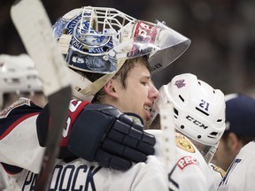 REGINA, SASK :  May 27, 2018  --  Host Regina Pats goalie Max Paddock (33) and Host Regina Pats forward Nick Henry (21) hug after losing the final game of the 100th anniversary of the Memorial Cup at the Brandt Centre in Regina.  QMJHL Acadie-Bathurst Titan beat the Host Regina Pats 3-0. TROY FLEECE / Regina Leader-Post