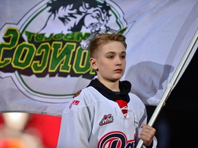 A young boy carries a Humboldt Broncos flag at the Memorial Cup opening ceremony at Mosaic Stadium on Thursday night. BRANDON HARDER