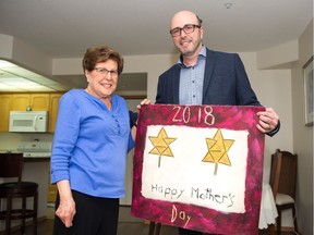 Bruce Belmore, right, delivers his mom Christine Belmore a special Mother's Day card at her home in Regina. It is a replica of one Bruce and his brothers made with toothpicks for their mother 51 years ago.