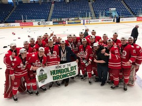 The Notre Dame Hounds pose with a Humboldt Broncos banner after winning the Telus Cup on Sunday in Sudbury, Ont.