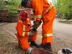 Crews prepare water lines to help protect the Waskesiu townsite on Friday, May 25, 2018. (Parks Canada / Handout photo) Saskatoon StarPhoenix