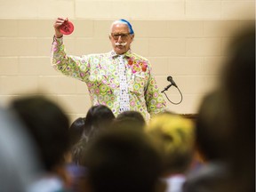 Patch Adams holds up a Whoopee Cushion as he speaks to children at St. Michael's Community School in Regina. Adams is a doctor and clown whose life inspired the 1998 Robin Williams movie, Patch Adams.