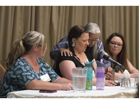 Melissa Stone, from left, Carrie Blaydon, who is being comforted by elder Lorna Standingready, and Priscilla Robert, from the Ma Mawi Wi Chi Itata Centre in Winnipeg, were the keynote speakers at the Provincial Association of Transition Houses and Services (PATHS) conference in Regina.