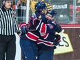 Sam Steel, right, and Jake Leschyshyn celebrate after helping the Regina Pats win Friday's Memorial Cup semi-final at the Brandt Centre.
