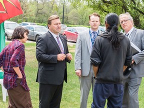MLA Ken Cheveldayoff, second from left, and political staffers meet with members of a protest camp in front of the Saskatchewan legislative building.