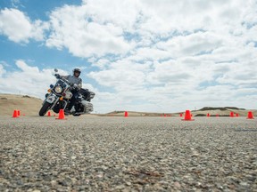 An RCMP officer rides a motorcycle during a RCMP motorcycle recertification course taking place at RCMP Depot in Regina.