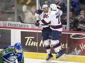 Jared Legien, left, and Matt Bradley of the Regina Pats, shown celebrating a goal against the Swift Current Broncos in the 2018 WHL playoffs, hope to be rejoicing again after the teams meet in the Memorial Cup's preliminary-round finale on Wednesday.