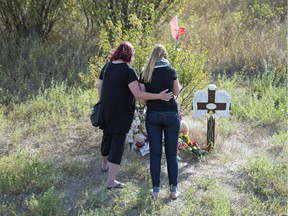 REGINA, SASK : August 24, 2017 -- Marion Haluik, left, joins her granddaughter Dakota Schmidt at a roadside memorial at the site of a crash where Dakota's mother, Daphne, was killed by an impaired driver approximately 40km's north of Regina on Highway 6. TROY FLEECE / Regina Leader-Post TROY FLEECE, Regina Leader-Post