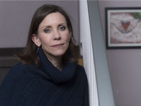 Gwyn Tremblay, executive director of SOFIA House, sits on the stairs of the organization's apartment building.