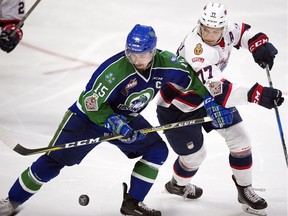 Swift Current Broncos captain Glenn Gawdin, left, battles with Matt Bradley of the Regina Pats during the 2018 Memorial Cup.