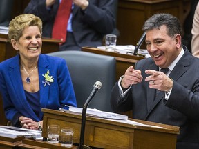 Ontario Premier Kathleen Wynne with Finance Minister Charles Sousa as he delivers the provincial budget on March 28, 2018.
