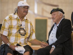 Residential school survivor, Eugene Arcand, left, and Holocaust survivor, Nate Leipciger speak during a presentation to students at the Cathedral of the Holy Family in Saskatoon on June 4, 2018.