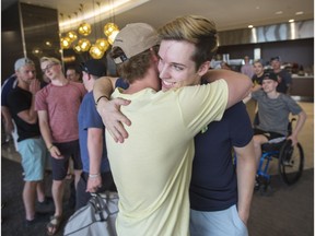 Humboldt Broncos bus crash survivor Xavier Labelle, right, greets teammate Tyler Smith during their layover in Calgary, before heading to Las Vegas for the NHL awards, in Calgary, AB on Monday, June 18, 2018.