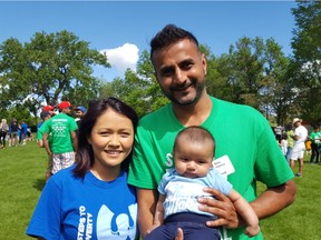 Anis Momin, the main organizer of the World Partnership Walk in Regina, stands with his wife Nadia Akbar Kamal and their three-month-old daughter the morning of the walk at Wascana Centre. As a family, they have raised $1,500 to help end global poverty.