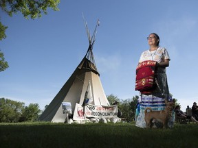 Debbie Baptiste, mother of the late Colten Boushie, stands in the protest camp on the grounds of the Legislative Building in Regina. Baptiste brought along Colten's dog Chico.