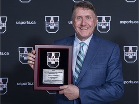 Former University of Regina athletic director Dick White with the Austin-Matthews Award on Monday in Vancouver.