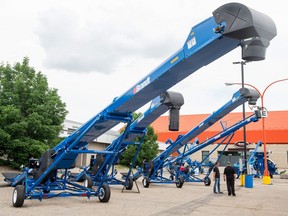 Brandt grain conveyors and an auger sit in a row ready for Canada's Farm Progress Show at Evraz Place.