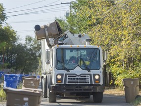 A City of Regina garbage truck picks up a trash bin