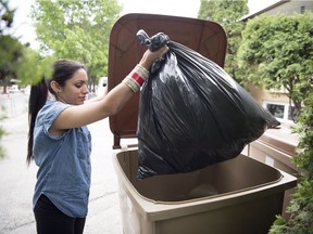 Ducky Day Care Co-Op employee Gursharan Kaur takes out the garbage in Regina.