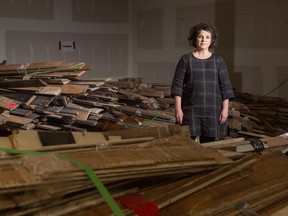 Jackie Schmidt, president of Heritage Regina, stands among some of the materials which will be included in an online auction being put on by Heritage Regina. Many of the items are building materials removed from the College Avenue Campus of the University of Regina.