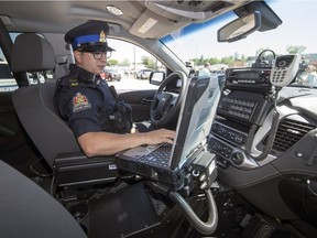 Saskatchewan Highway Patrol traffic officer Dolton Johnson sits in the newly equipped vehicle that will soon be hitting the highways in Saskatchewan. The unveiling of the new vehicles was held at the Department of Highways office in Regina.