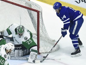 Texas Stars goaltender Mike McKenna makes a save on Toronto Marlies centre Adam Brooks during the AHL's Calder Cup final.