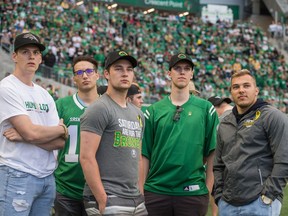 Members of the Humboldt Broncos watch a video tribute as part of the Riders' "Humboldt Strong'' game on Saturday.
