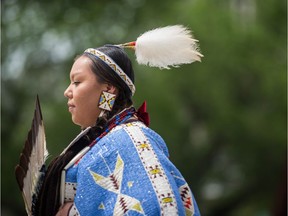 Kayla McArthur, with the Charging Bear Pow Wow dancers, performs a ladies' northern-style traditional dance in City Square Plaza during a National Indigenous Persons Day event.