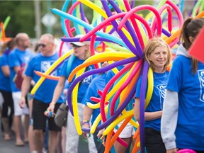 Participants walk in the Pride parade on 13th Avenue on June 16, 2018.