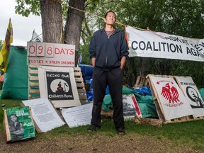 Prescott Demas stands at a protest camp in front of the Saskatchewan legislative building.