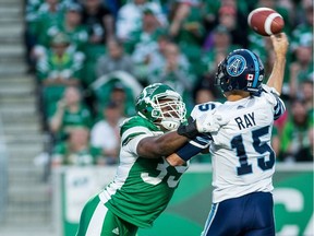 Charleston Hughes, left, sacked Toronto Argonauts quarterback Ricky Ray three times Friday to help the Saskatchewan Roughriders win 27-19.